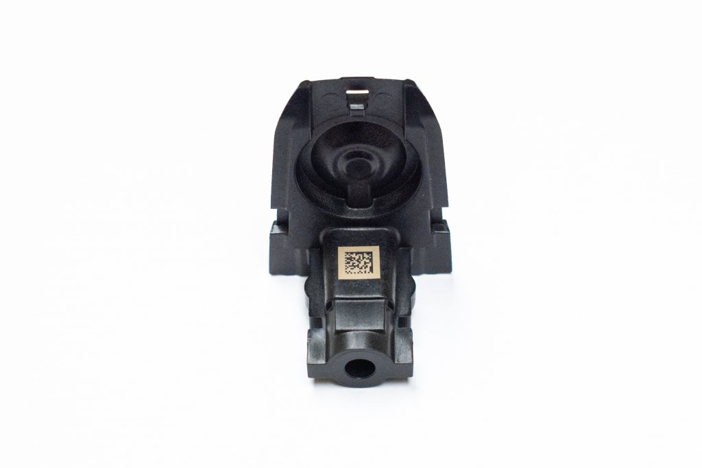 2D barcode marking up close up car door handle latch..